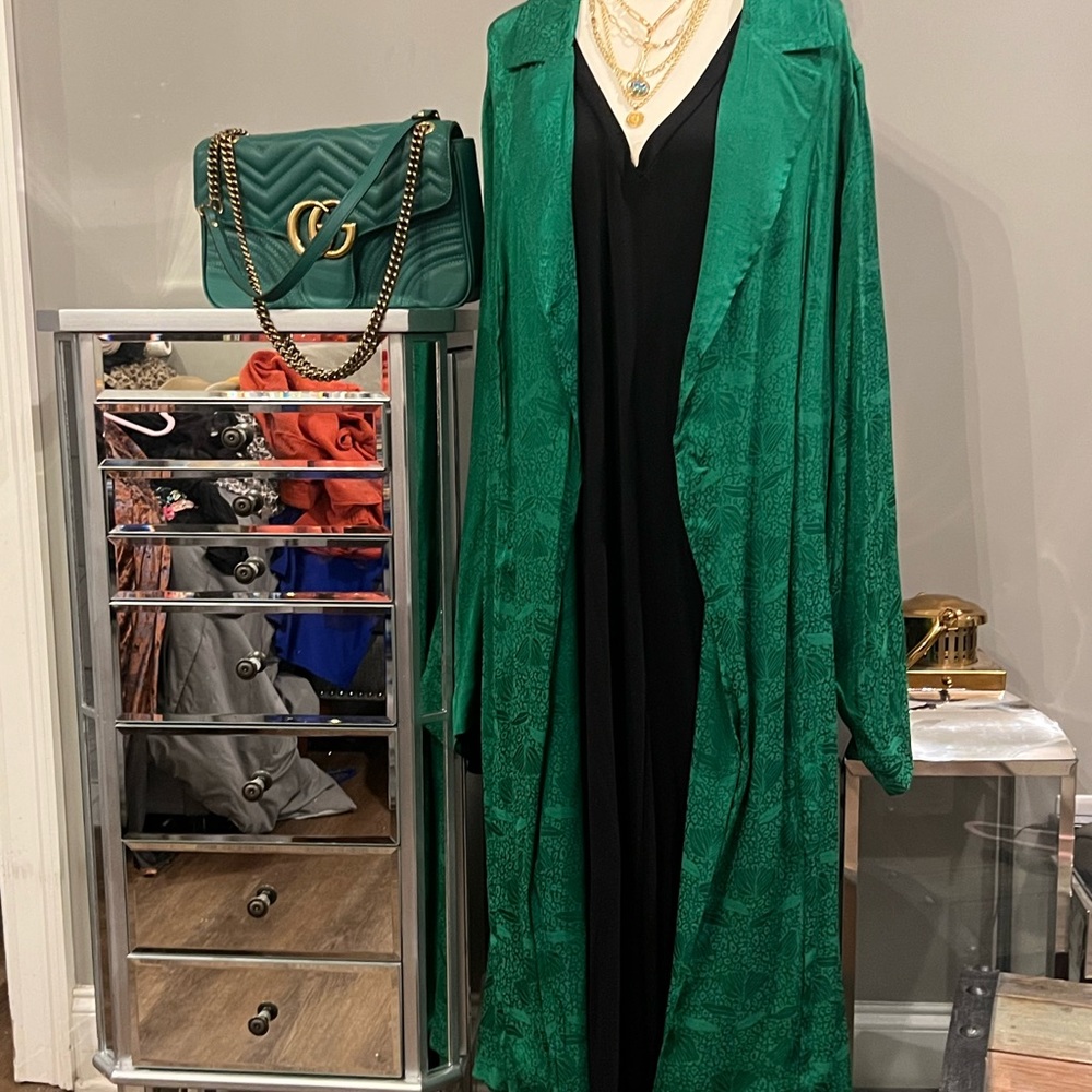 This new green duster has a flare for fashion cute and sassy.  Belted or not .